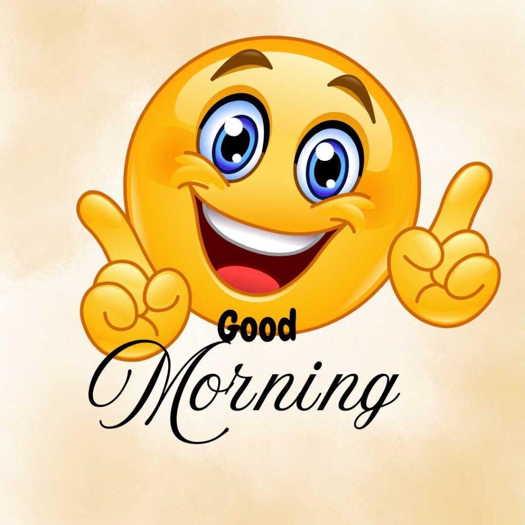 Happy smiling yellow emoji with big blue eyes pointing up, featuring Good Morning text on a beige background