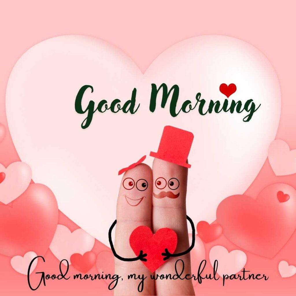 Cute finger art couple with big cartoon eyes, a top hat, and a mustache holding a red heart against a pink background filled with hearts.
