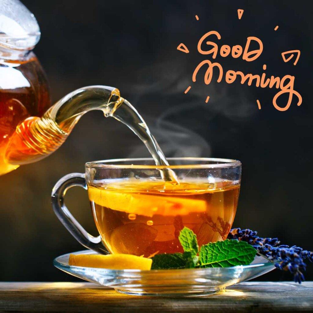 Pouring hot tea from a teapot into a glass cup with lemon and mint, featuring a Good Morning greeting.
