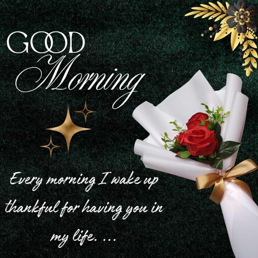 A small bouquet of fresh red roses wrapped in premium white paper with a gold ribbon on the right, placed against a textured dark green background with a gold flower ornament and white text that reads Good Morning Every morning I wake up thankful for having you in my life.