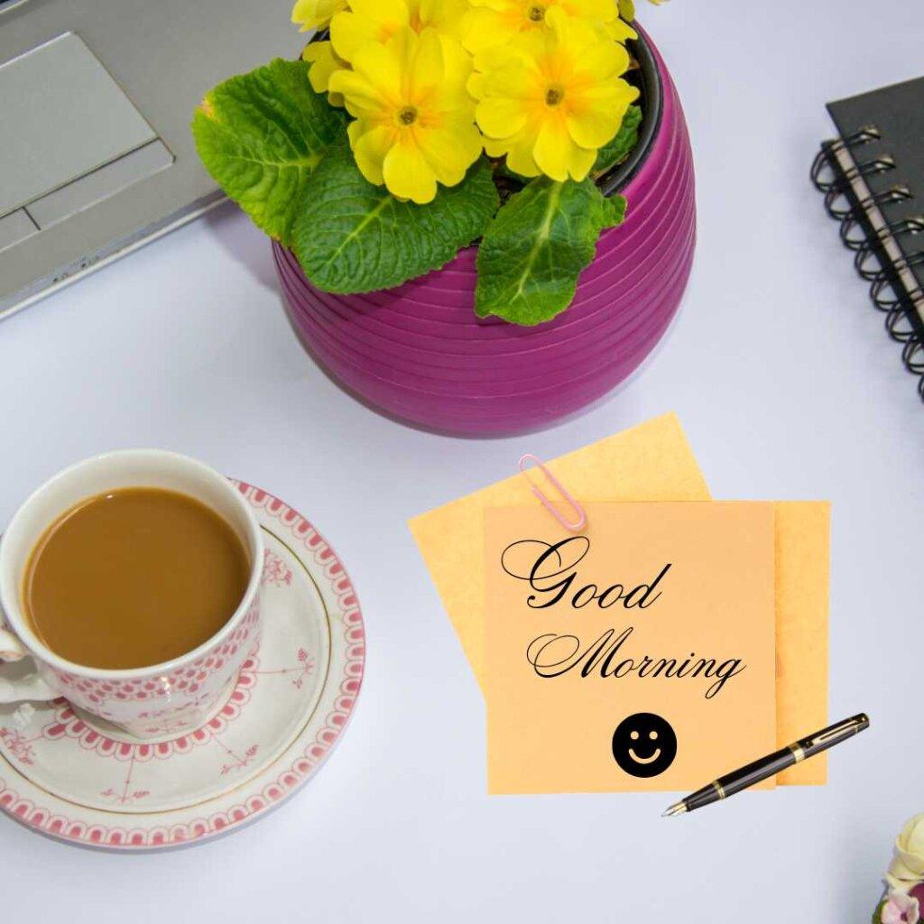 Two fresh red roses with rich green leaves lying elegantly on a premium black marble texture background, featuring bold white cursive text reading Good Morning.
