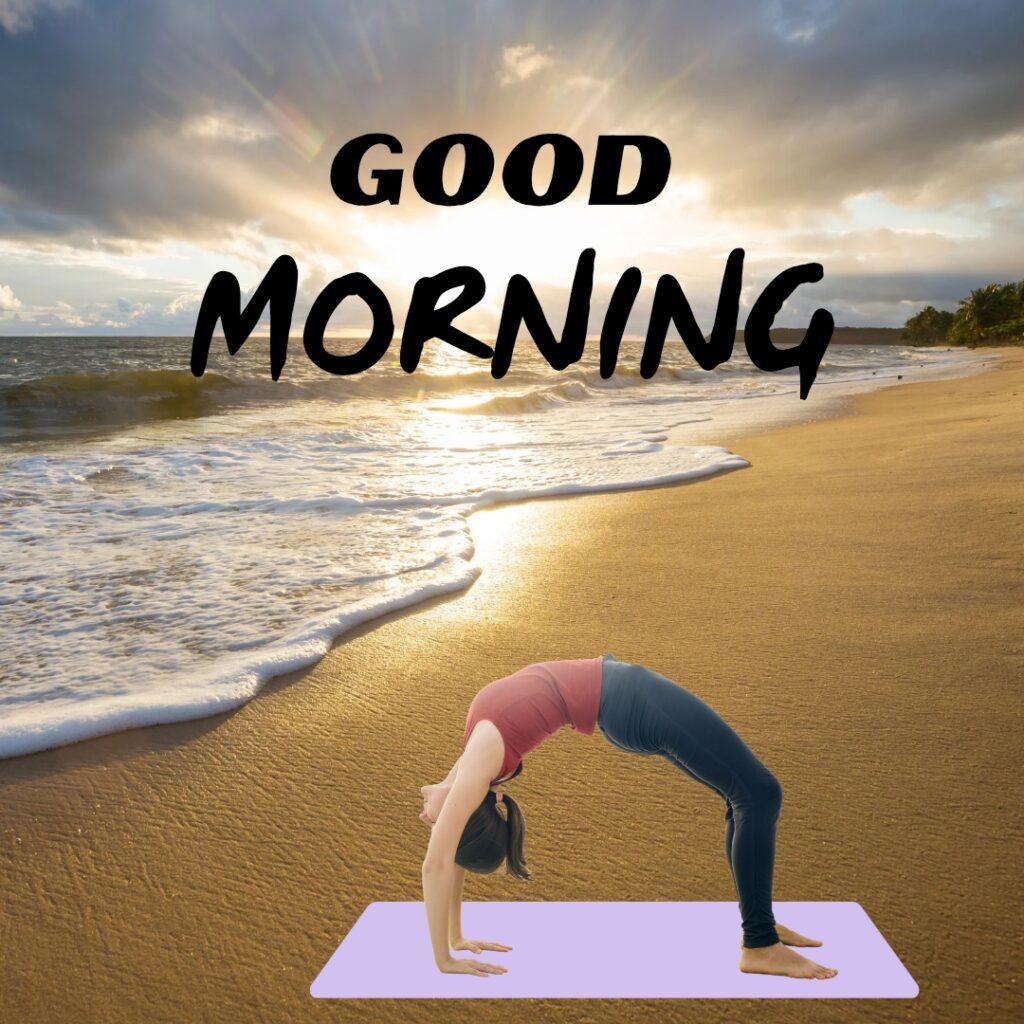 A woman practicing a yoga wheel pose on a purple mat at the beach during a bright sunrise with Good Morning text.
