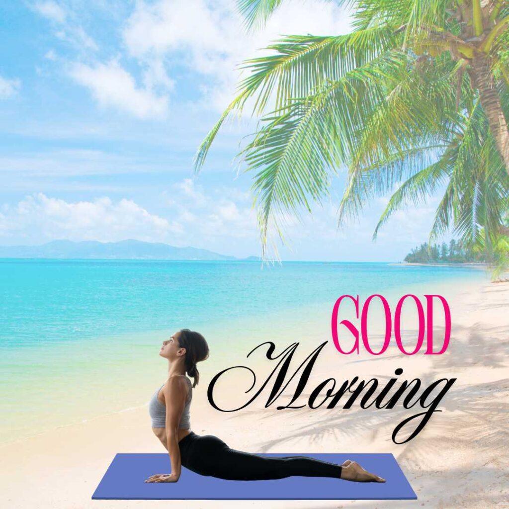 A woman practicing a cobra yoga pose on a purple mat at a tropical beach under a palm tree with Good Morning text.