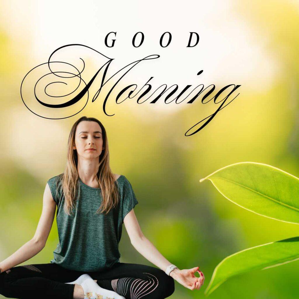 A young woman meditating in a cross-legged yoga pose with closed eyes against a blurred green nature background and elegant Good Morning text.